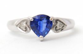 An 18ct sapphire and diamond ring, the pear shape Ceylon sapphire, approx. 7mm long, set to either