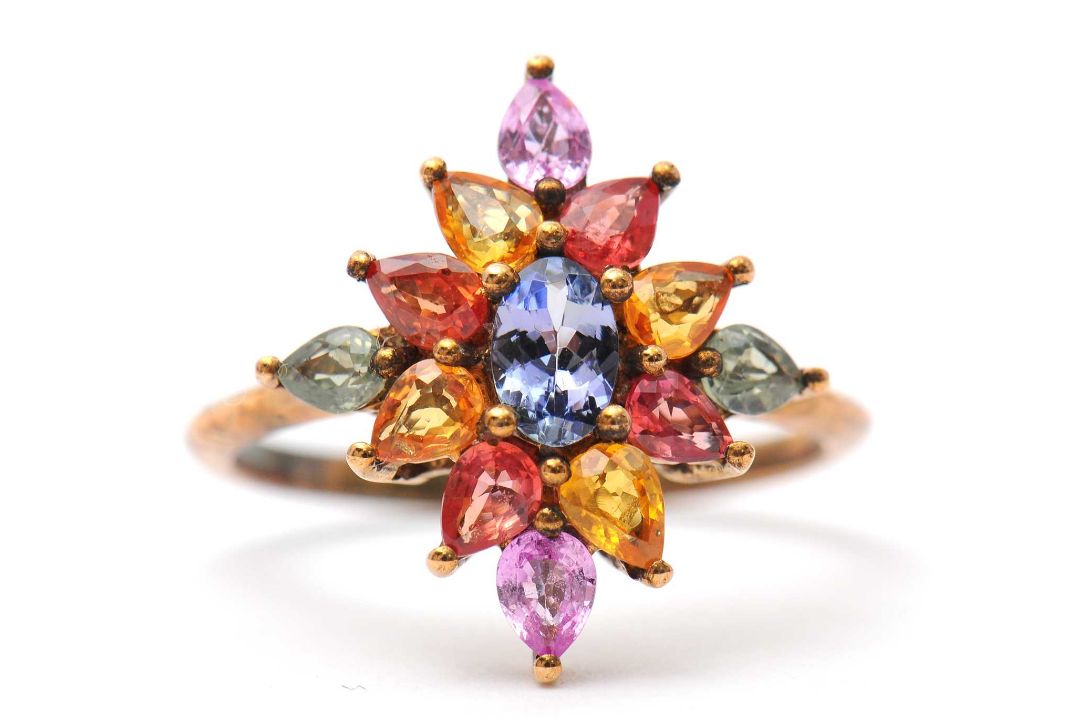 A 9ct multi gemset ring, set with oval and pear shape sapphires, topaz and quartz, with plain band - Image 1 of 7