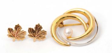 A bi-colour cultured pearl brooch, stamped 9ct, 22mm diameter, 1.9g; and a pair of 9ct maple leaf