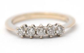 An 18ct diamond ring, set with five round brilliant cut diamonds, total 0.25cts, with plain band