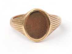 A 9ct signet ring, with plain oval disc, tapering shoulders and plain band hallmarked Birmingham