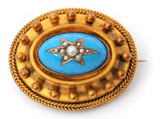 An Archeological revival brooch, with central oval turquoise blue enamellled dome set with a seed