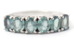 A 9ct Russian alexandrite ring, set with six oval alexandrites, with plain band hallmarked