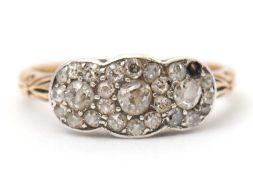 A diamond cluster ring, with three small clusters of old mine cut diamonds (one stone missing), with