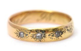 A diamond ring, set with three small rose cut diamonds, with closed backs, all set in unmarked