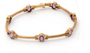 An amethyst bracelet, with collet mounted oval amethysts and slightly curved long links,