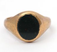 A 9ct bloodstone ring, with oval inset bloodstone, tapered shoulders and plain band hallmarked