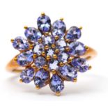 A 9ct tanzanite cluster ring, the cluster formed of round, oval and pear shape tanzanites, with