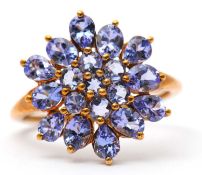 A 9ct tanzanite cluster ring, the cluster formed of round, oval and pear shape tanzanites, with