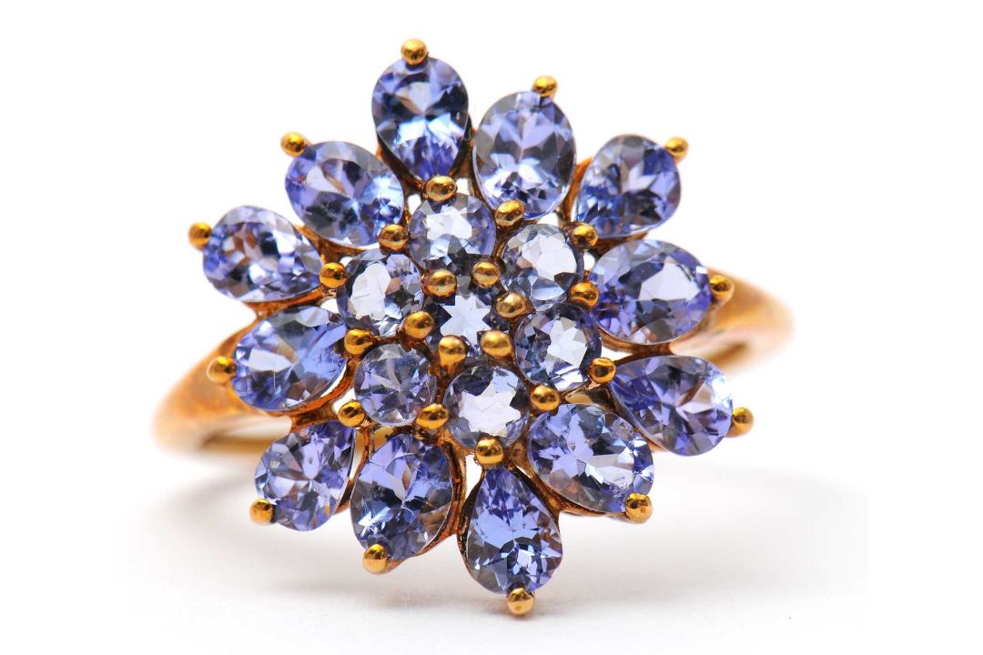 A 9ct tanzanite cluster ring, the cluster formed of round, oval and pear shape tanzanites, with - Image 1 of 7