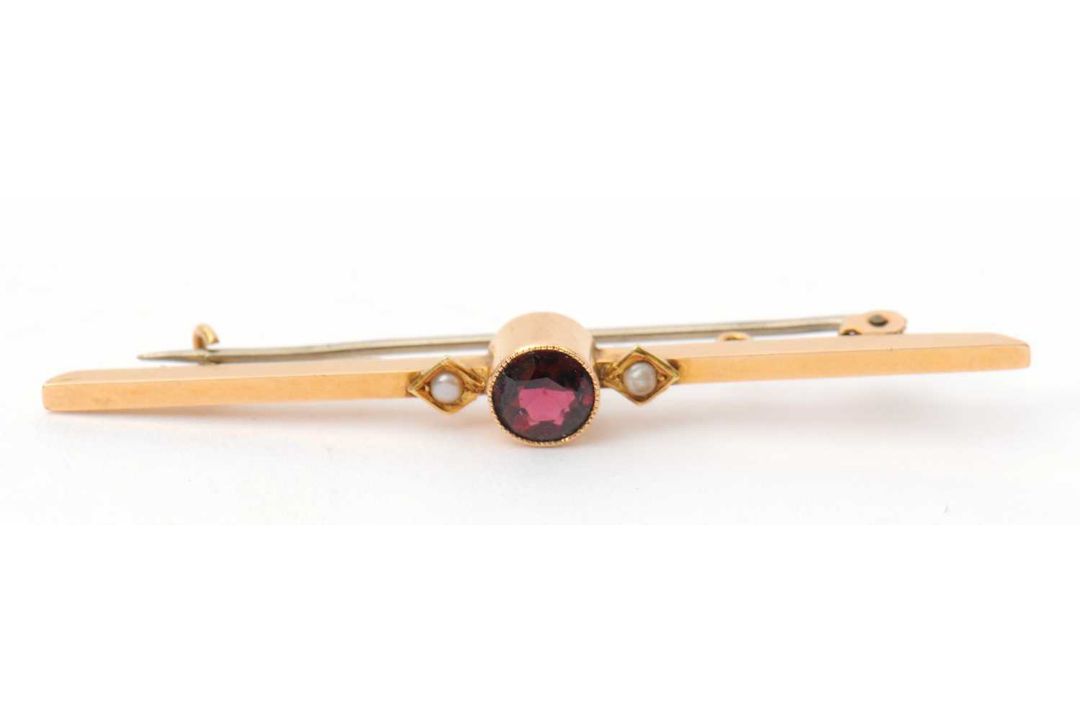 A garnet and seed pearl bar brooch, with central round garnet in millegrain collet mount, with a - Image 2 of 3