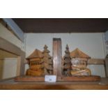 Two wooden bookends with carved alpine cottages