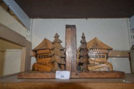 Two wooden bookends with carved alpine cottages