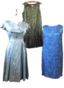 Three mid 20th century dresses: incluidng a pastel blue fitted stin dress (estimated approx. size