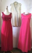 Three mid 20th century evening/cocktail dresses, including a long pink shift dress with high