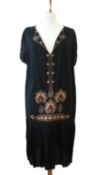 An early 20th century shift dress, with v-neck and orange and gilt embroidery to collar, cap