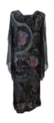 A 1920's beaded dress, in fine black net with allover beaded decoration and loose chiffon sleeves