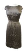 A 1950' satin shift dress by Simpsons Picadilly, in taupe satin, with cap sleeves and box pleat rear