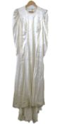 A mid 20th century wedding dress, the cream satin dress with V-neck, fitted bodice, tapered long