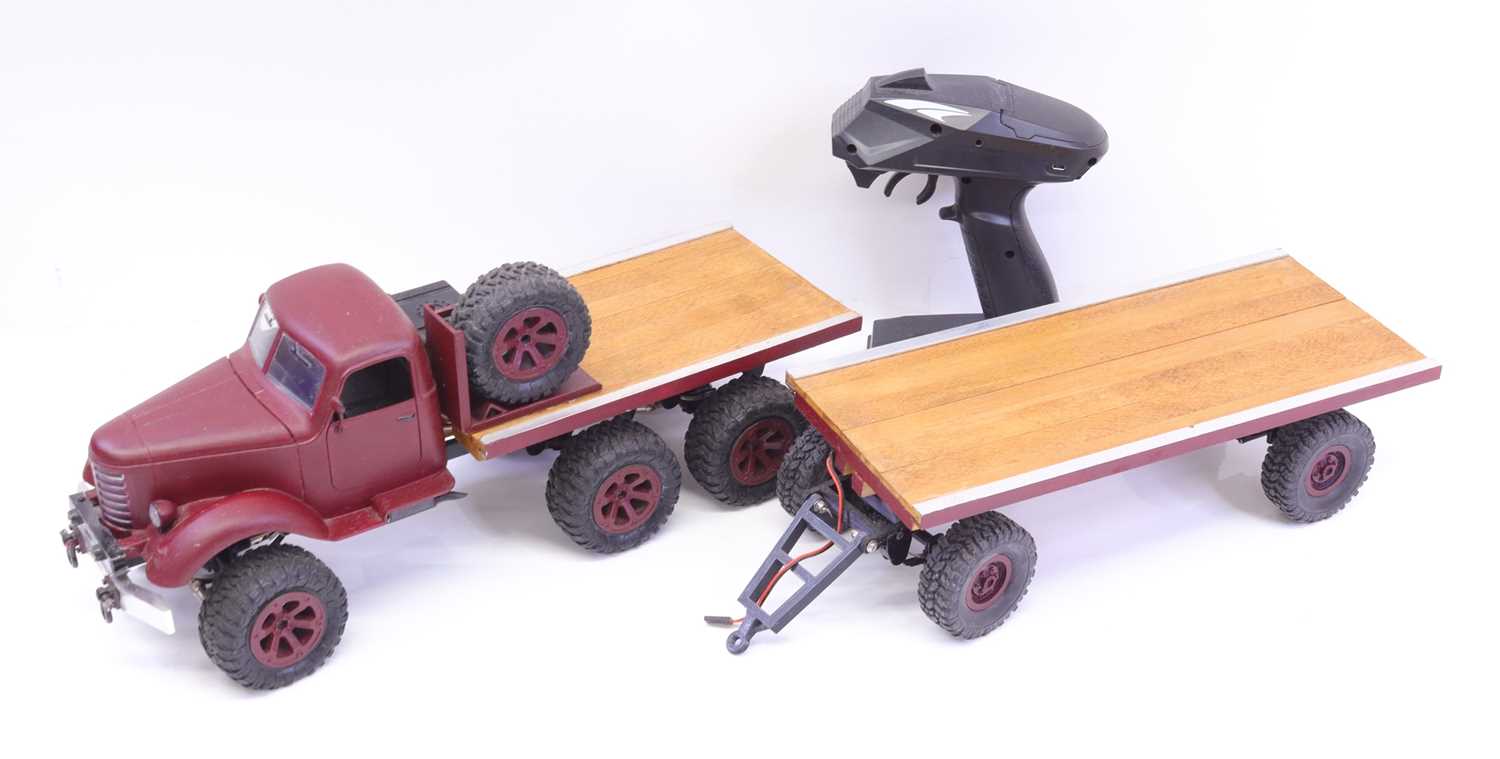 A well made plastic and wooden radio controlled model of a 6 wheel military truck with matching 4