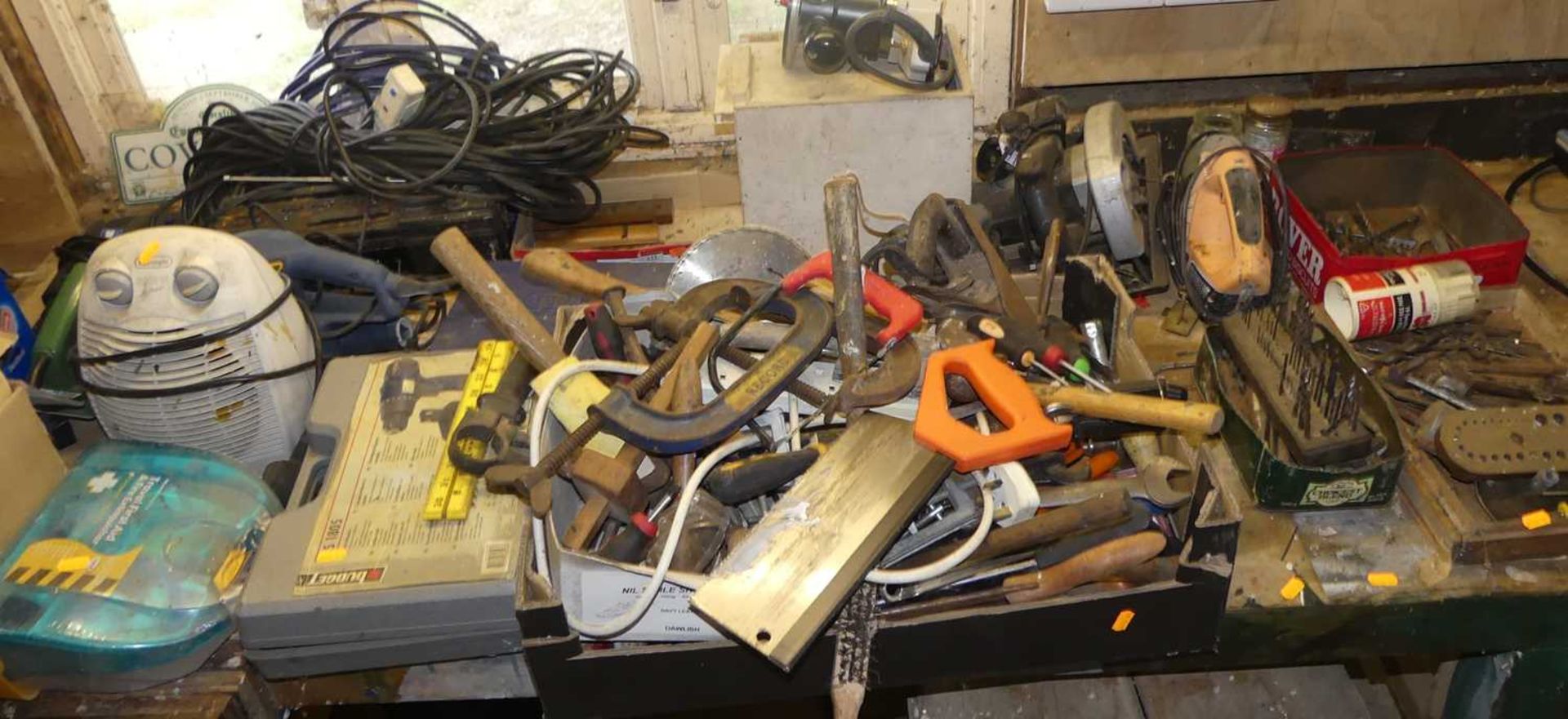 A wooden workbench with vice; together with a large number of mixed tools, to include various