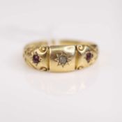 An Edwardian 18ct gold ruby and diamond 3 stone ring, the small stones each being gypsy set, size W,