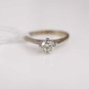 A modern 18ct white gold diamond solitaire ring, the four claw round set brilliant weighing approx