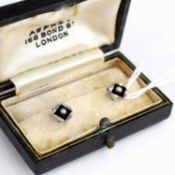 A pair of 9 carat white gold collar studs, each set with an onyx panel and seed pearl, stamped