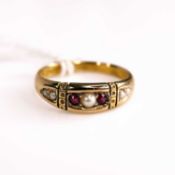 A late Victorian 15ct gold ruby and seed pearl set half hoop ring, Chester 1891, size M/N, 2.6g