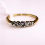 An 18ct gold and platinum diamond five stone ring, arranged as five graduated bezel set old round