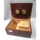 Mahogany humidor containing various cigars