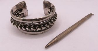 Eastern silver bangle and a silver propelling pencil, 3.5oz t