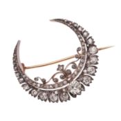 A VICTORIAN DIAMOND CRESCENT BROOCH.