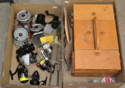 Two boxes of assorted fishing items, to include reels; a wooden storage box; fishing tackles, etc.