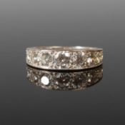 An 18ct white gold and diamond half hoop eternity ring set with a round brilliant cut diamond