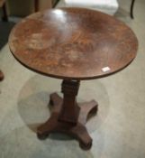 A 19th century mahogany wine table, the circular top supported on a squared column, terminating to a