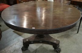 A 19th century mahogany tilt top centre table, the top over a turned tapering pedestal with