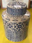 A decorative pottery jar and cover, decorated with blue glazes of stylised flowers and vertical