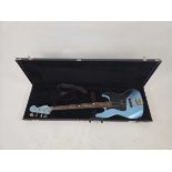 +VAT A Chinese metallic blue Fender Squier jazz bass with strap in a Fender branded hard carry case