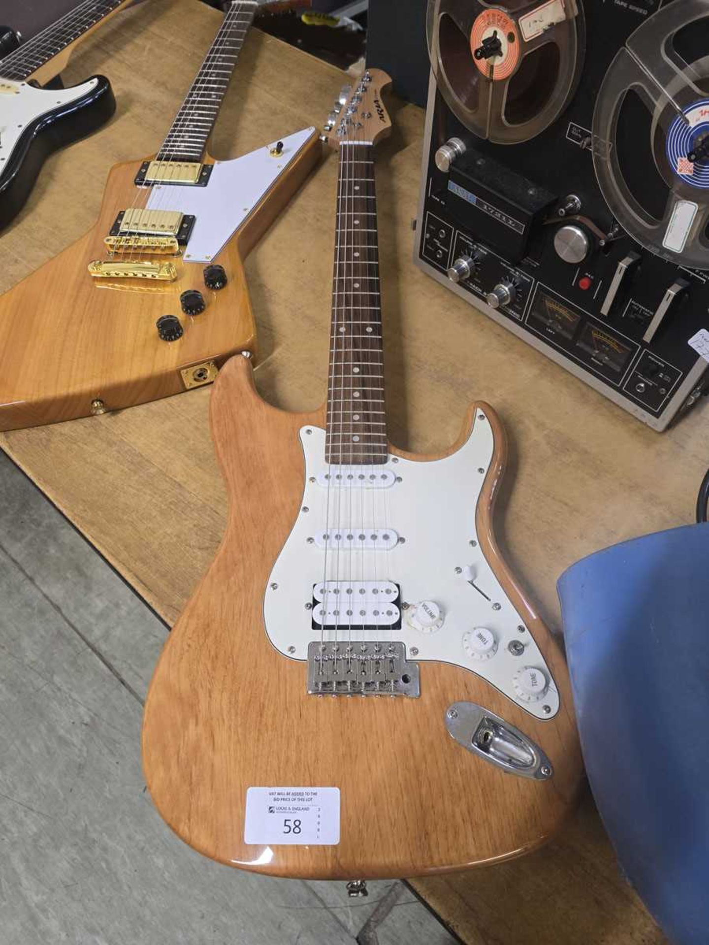 +VAT An Aria STG-Series electric guitar in natural wood finish