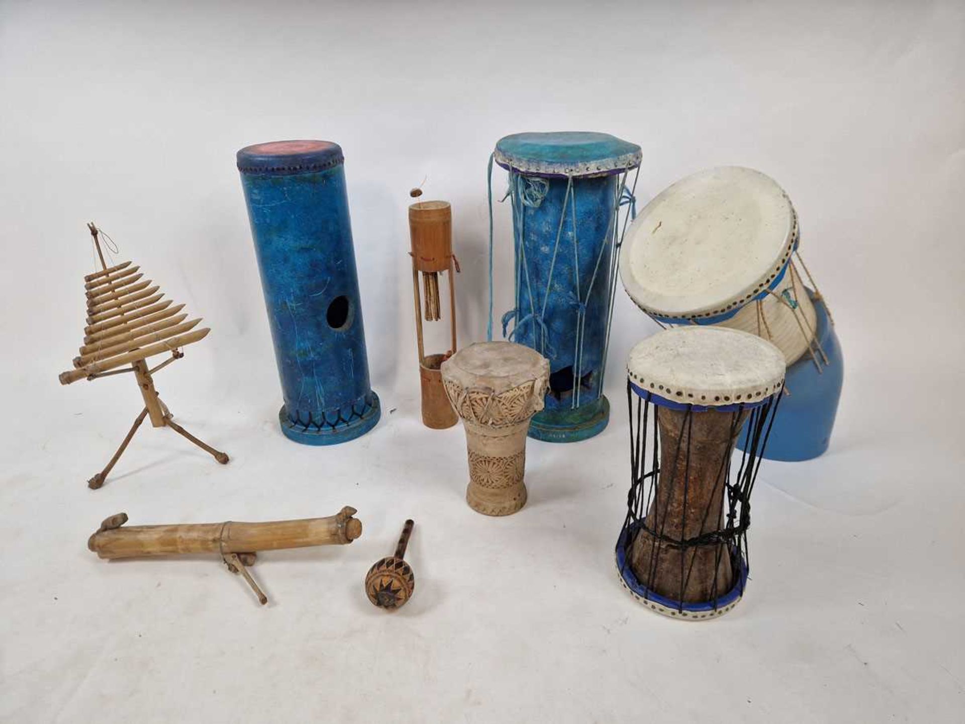 A selection of percussion instruments to include bamboo wind chime, hand crafted rainstick, hand