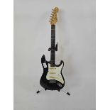 +VAT A Korean black Fender Squier Stratocaster electric guitar serial no. S957382.