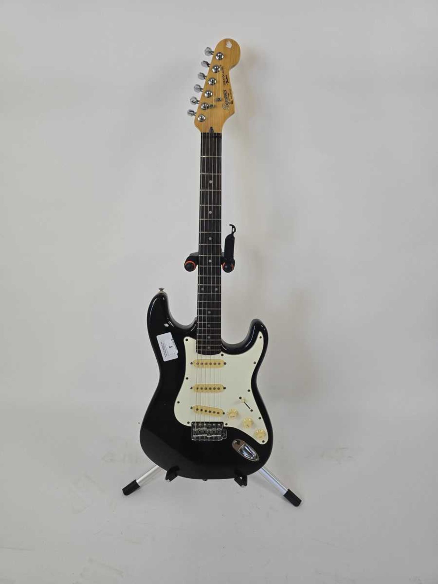 +VAT A Korean black Fender Squier Stratocaster electric guitar serial no. S957382.