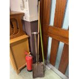 A spade along with a long handled garden hoe and long handled garden fork