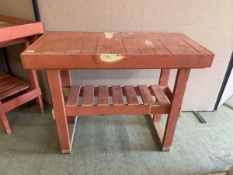 A pink painted weathered garage table with slatted undertier