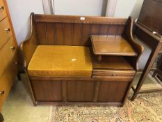A mid-20th century oak telephone seat
