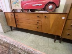 A G-Plan teak sideboard with three drawers flanked by cupboard doors