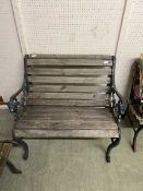An ornate metalwork framed two seat garden bench