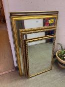 Three ornate gilt framed wall mirrors along with two other rectangular wall mirrors