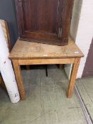 A distressed pine square top kitchen table